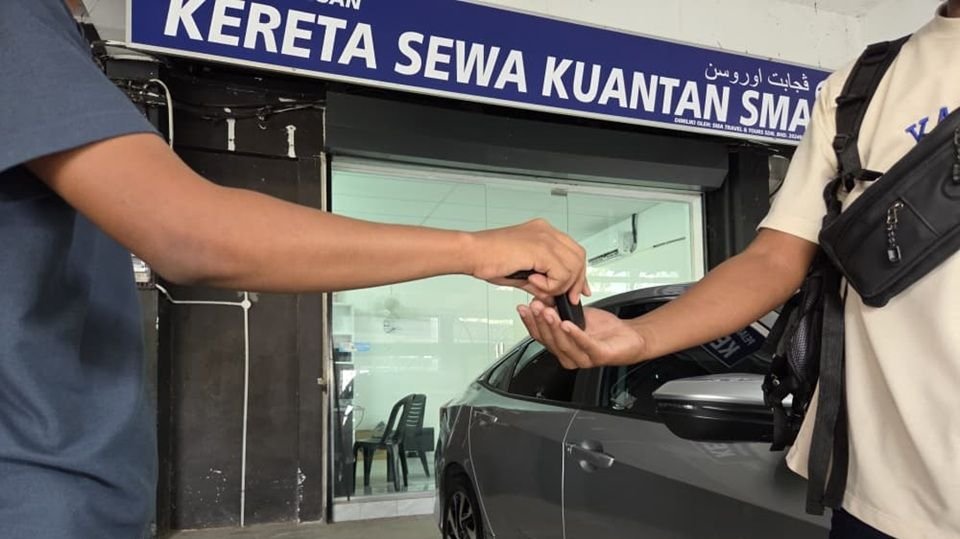 Staf SMA menyerahkan kunci kereta kepada pelanggan di hadapan pejabat SMA Car Rental, Kuantan